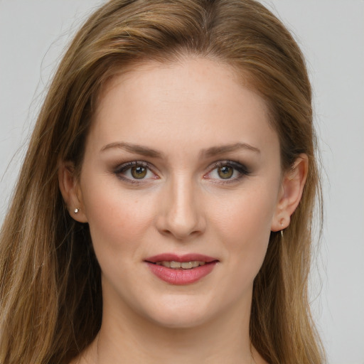 Joyful white young-adult female with long  brown hair and green eyes