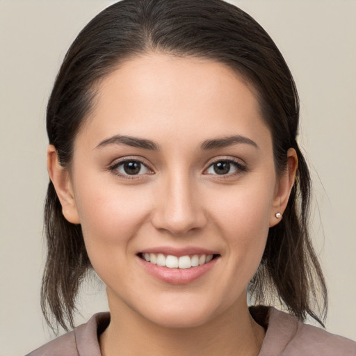 Joyful white young-adult female with medium  brown hair and brown eyes