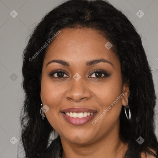 Joyful black young-adult female with long  brown hair and brown eyes