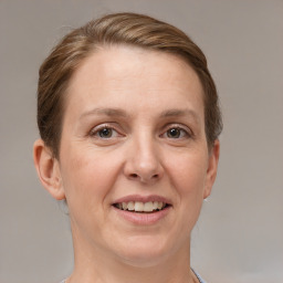 Joyful white adult female with short  brown hair and grey eyes