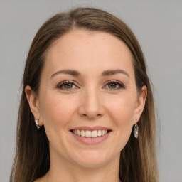 Joyful white young-adult female with long  brown hair and grey eyes