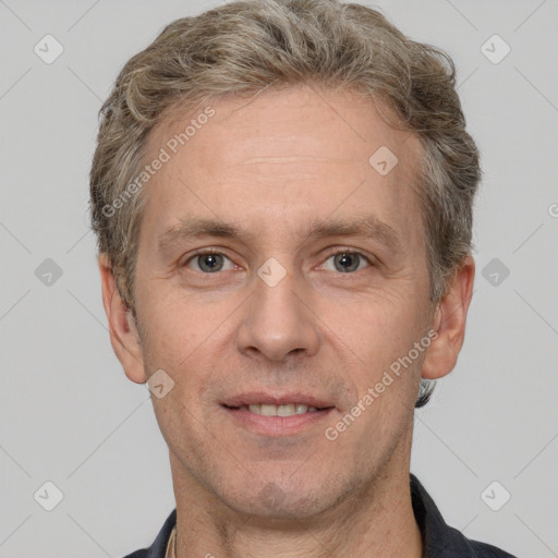 Joyful white adult male with short  brown hair and grey eyes