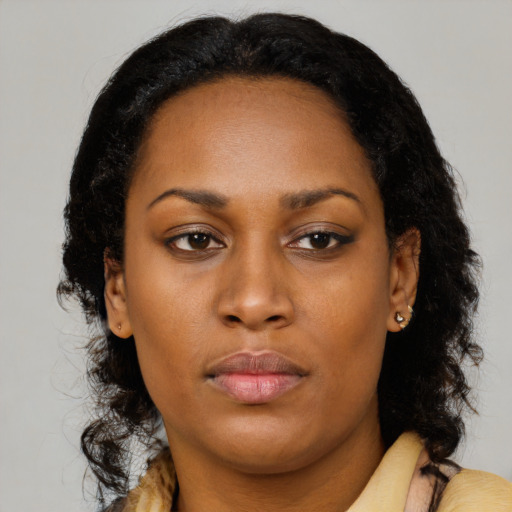 Neutral black young-adult female with long  brown hair and brown eyes