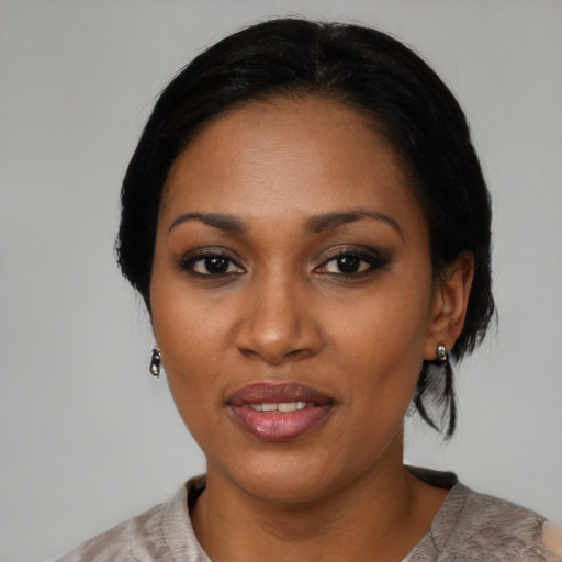 Joyful black young-adult female with medium  black hair and brown eyes
