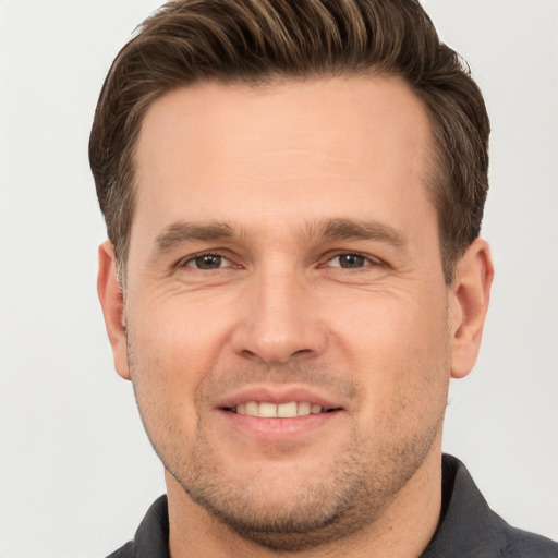 Joyful white young-adult male with short  brown hair and brown eyes