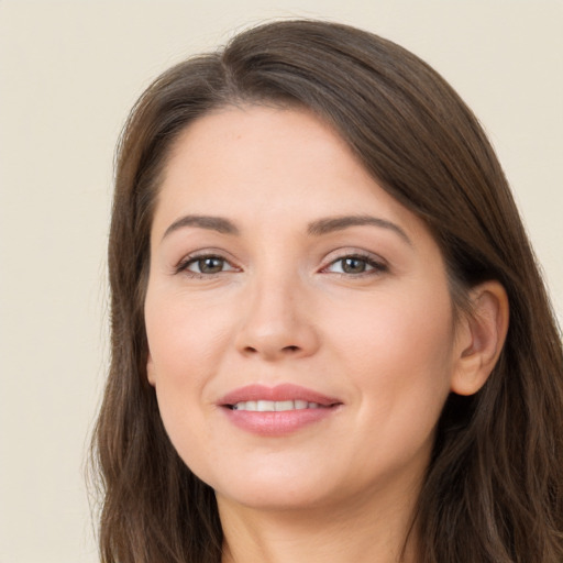 Joyful white young-adult female with long  brown hair and brown eyes