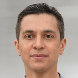 Joyful white adult male with short  brown hair and brown eyes