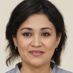 Joyful white adult female with medium  brown hair and brown eyes