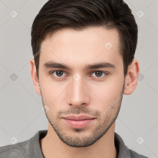 Neutral white young-adult male with short  brown hair and brown eyes