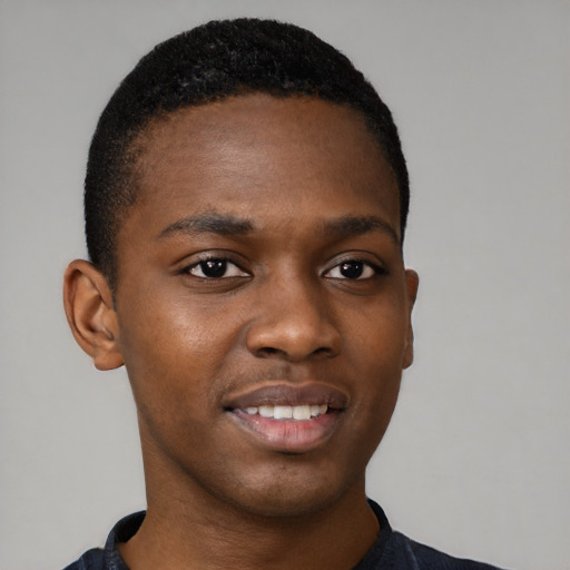 Joyful black young-adult male with short  brown hair and brown eyes