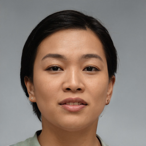 Joyful asian young-adult female with medium  brown hair and brown eyes