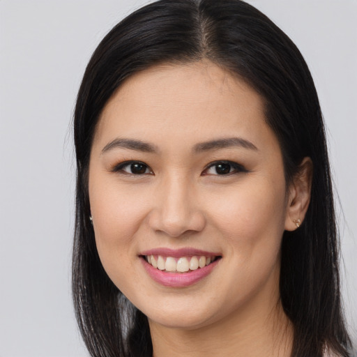 Joyful asian young-adult female with long  brown hair and brown eyes