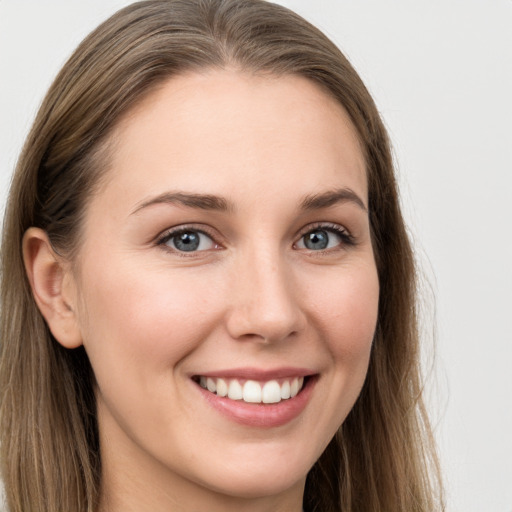 Joyful white young-adult female with long  brown hair and grey eyes