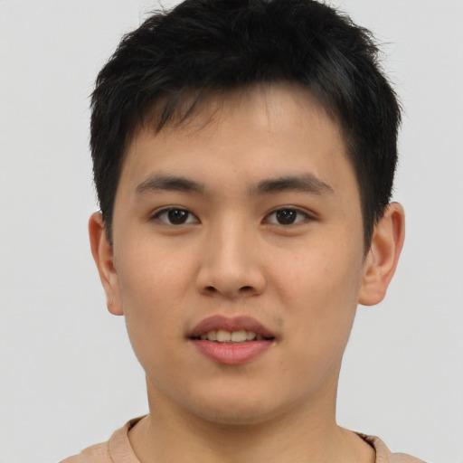 Joyful asian young-adult male with short  brown hair and brown eyes
