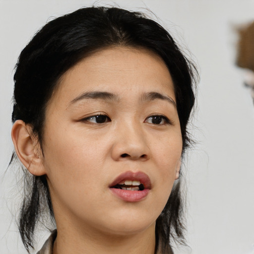 Neutral asian young-adult female with medium  brown hair and brown eyes