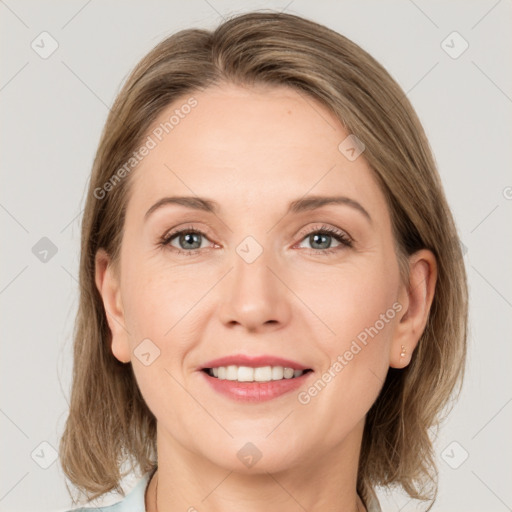 Joyful white adult female with medium  brown hair and grey eyes