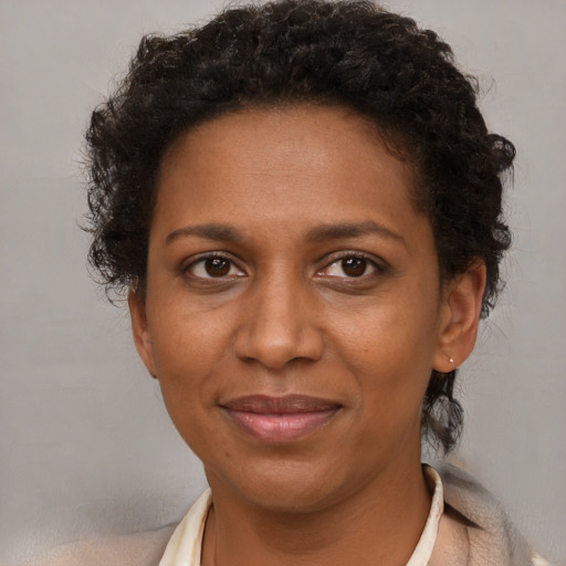 Joyful black adult female with short  brown hair and brown eyes