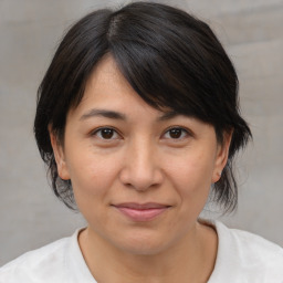 Joyful white adult female with medium  brown hair and brown eyes