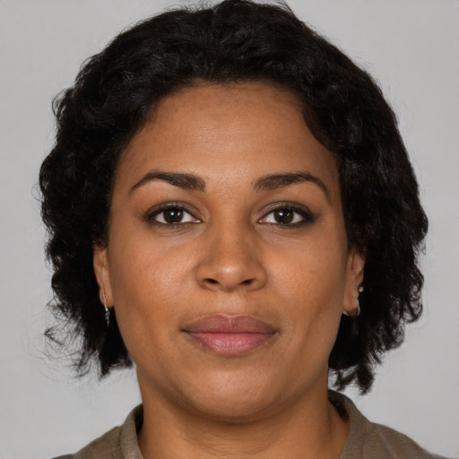 Joyful black adult female with short  brown hair and brown eyes