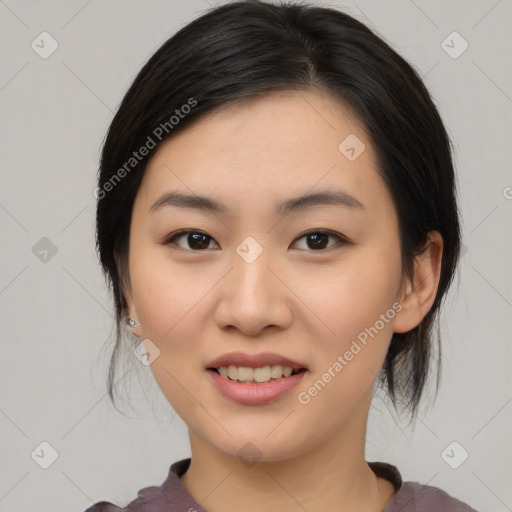 Joyful asian young-adult female with medium  black hair and brown eyes