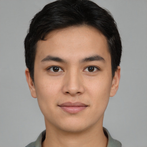 Joyful asian young-adult male with short  black hair and brown eyes