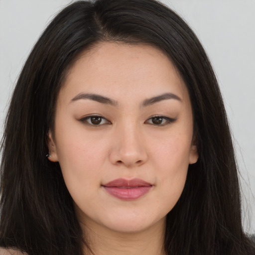 Joyful asian young-adult female with long  brown hair and brown eyes