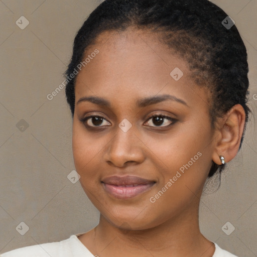 Joyful black young-adult female with short  black hair and brown eyes