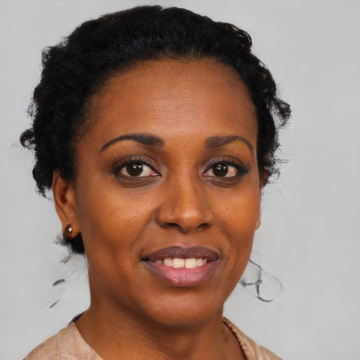 Joyful black young-adult female with medium  black hair and brown eyes