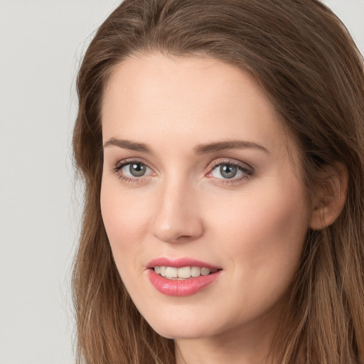 Joyful white young-adult female with long  brown hair and grey eyes