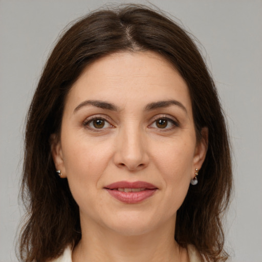 Joyful white young-adult female with medium  brown hair and brown eyes