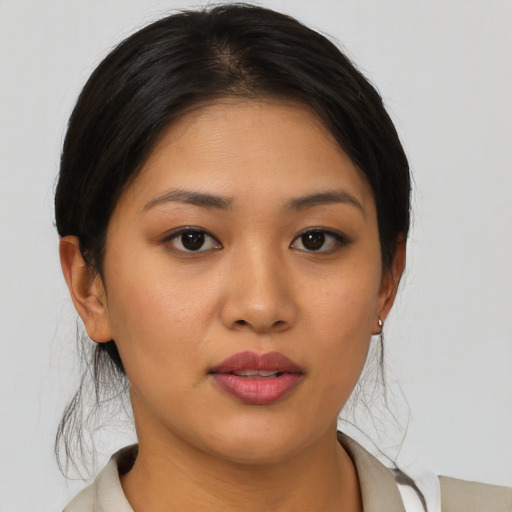Joyful asian young-adult female with medium  brown hair and brown eyes