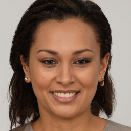 Joyful black young-adult female with medium  brown hair and brown eyes
