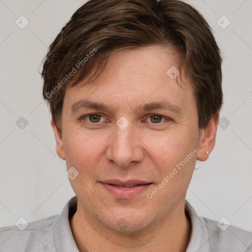 Joyful white adult male with short  brown hair and grey eyes