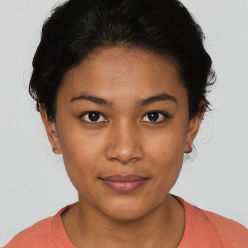 Joyful latino young-adult female with short  brown hair and brown eyes