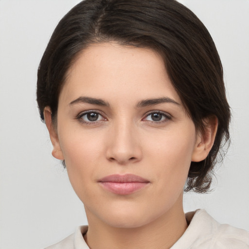 Joyful white young-adult female with medium  brown hair and brown eyes