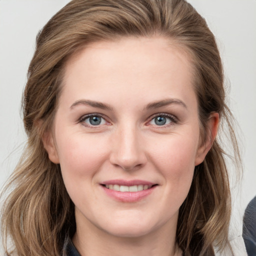 Joyful white young-adult female with medium  brown hair and grey eyes