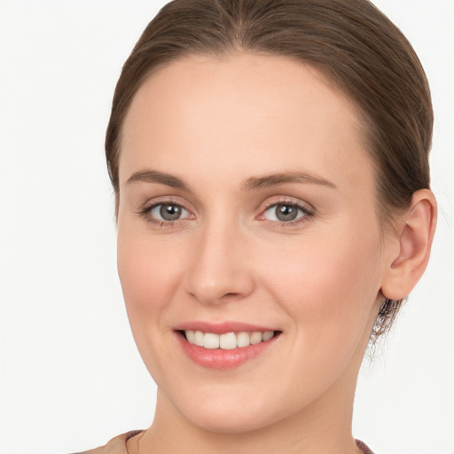 Joyful white young-adult female with long  brown hair and grey eyes