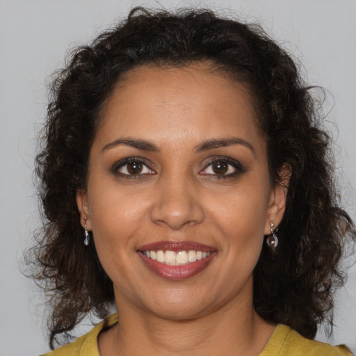 Joyful black young-adult female with medium  brown hair and brown eyes