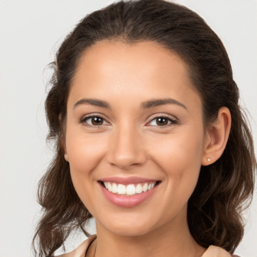 Joyful white young-adult female with medium  brown hair and brown eyes