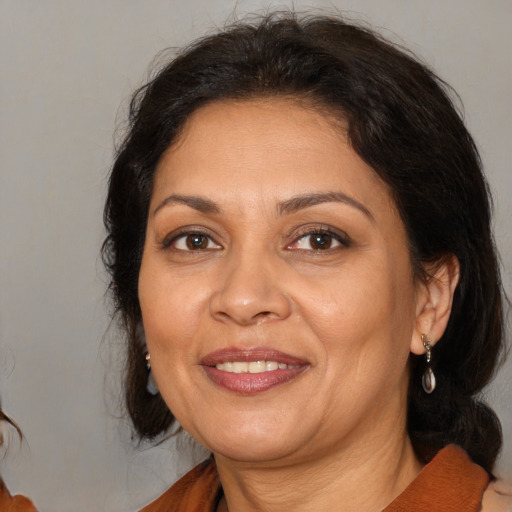 Joyful white adult female with medium  brown hair and brown eyes