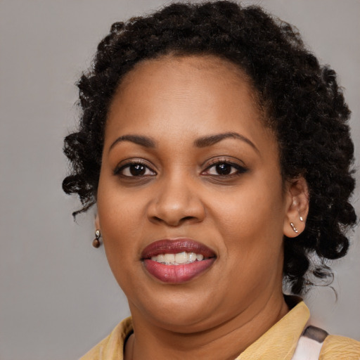 Joyful black young-adult female with medium  brown hair and brown eyes