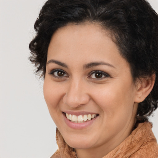 Joyful latino young-adult female with medium  brown hair and brown eyes