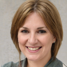 Joyful white adult female with medium  brown hair and grey eyes