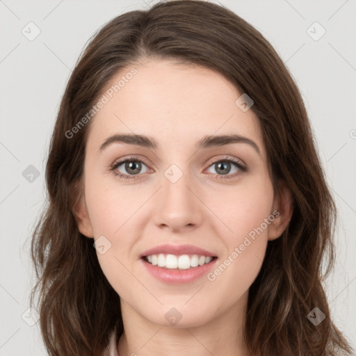 Joyful white young-adult female with long  brown hair and green eyes