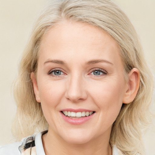 Joyful white young-adult female with medium  brown hair and blue eyes