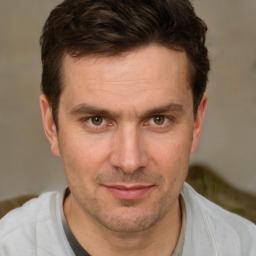 Joyful white adult male with short  brown hair and brown eyes