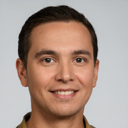 Joyful white young-adult male with short  brown hair and brown eyes