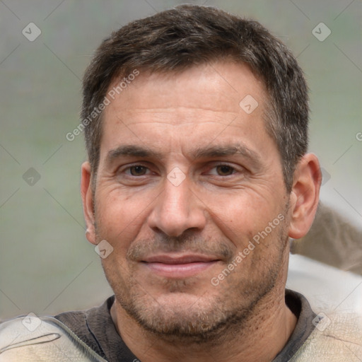 Joyful white adult male with short  brown hair and brown eyes