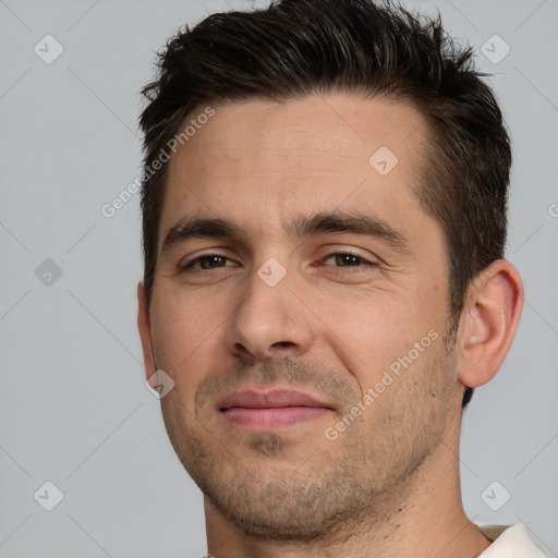 Joyful white adult male with short  brown hair and brown eyes