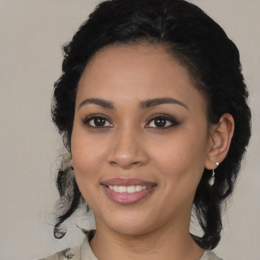 Joyful latino young-adult female with medium  black hair and brown eyes